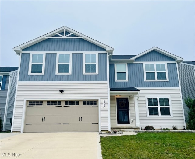 view of front of house with a front lawn and a garage