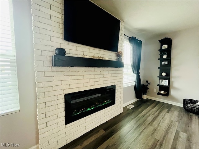 unfurnished living room with dark hardwood / wood-style floors and a fireplace