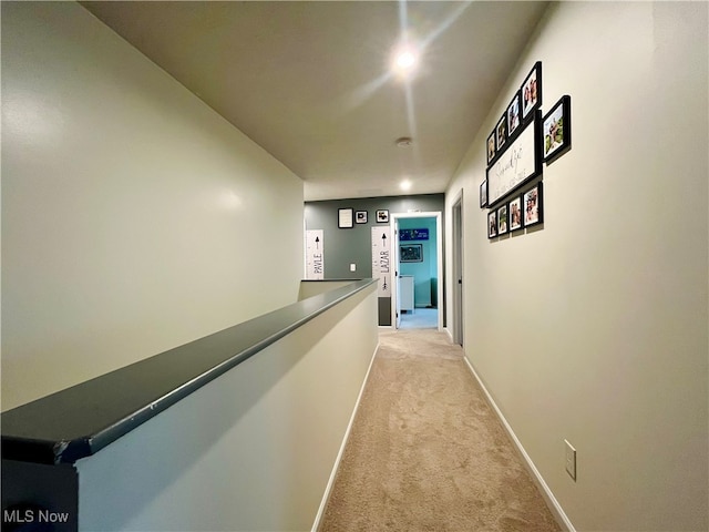 corridor featuring light colored carpet