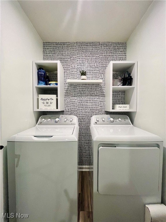 laundry area with tile walls and washing machine and clothes dryer