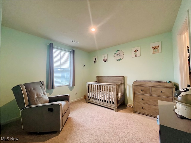 carpeted bedroom with a crib