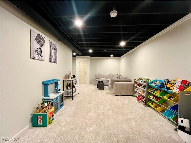 recreation room featuring carpet floors and crown molding