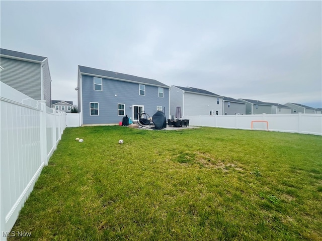 rear view of house with a lawn and a patio area