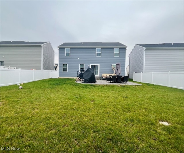 rear view of property with a patio area and a yard