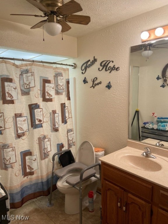 bathroom with tile patterned floors, vanity, toilet, and a textured ceiling