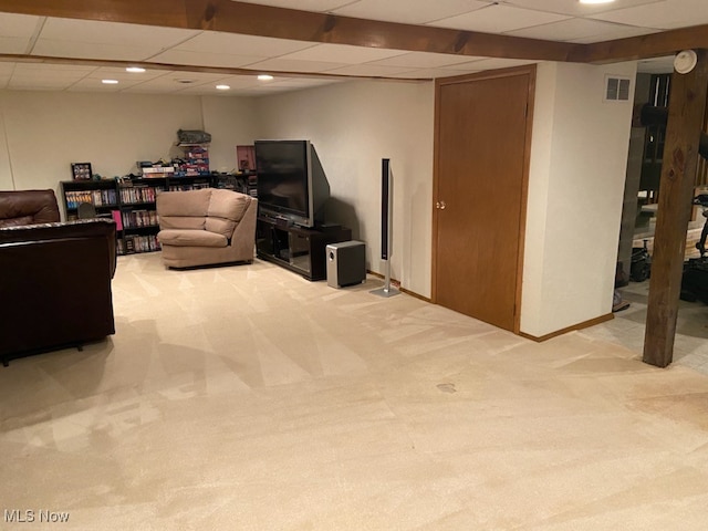 basement with light carpet and a drop ceiling