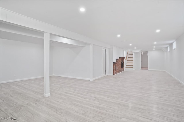 basement with light hardwood / wood-style floors