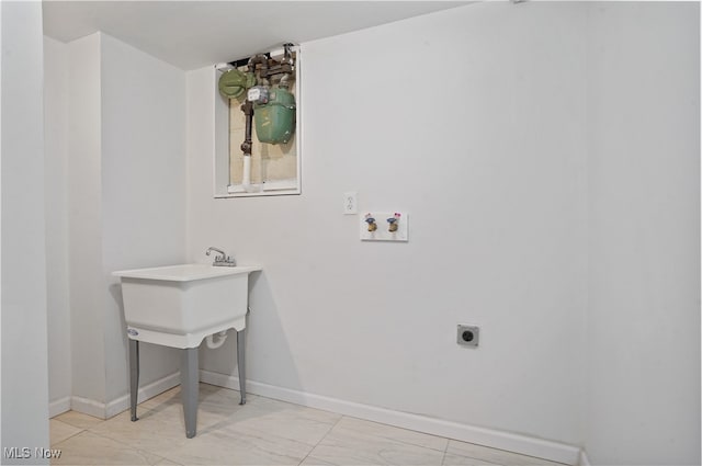 clothes washing area featuring hookup for an electric dryer and hookup for a washing machine