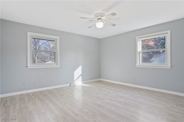 spare room with light hardwood / wood-style flooring, plenty of natural light, and ceiling fan