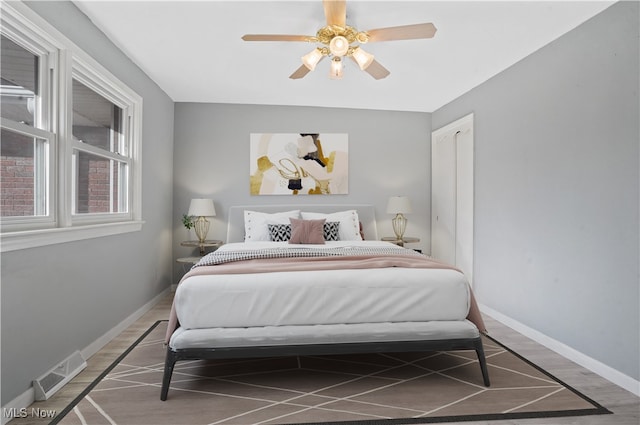 bedroom with ceiling fan and hardwood / wood-style flooring