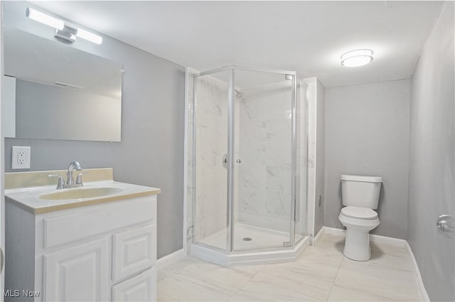 bathroom featuring vanity, toilet, and a shower with door