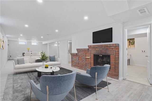 living room featuring a fireplace and light hardwood / wood-style floors