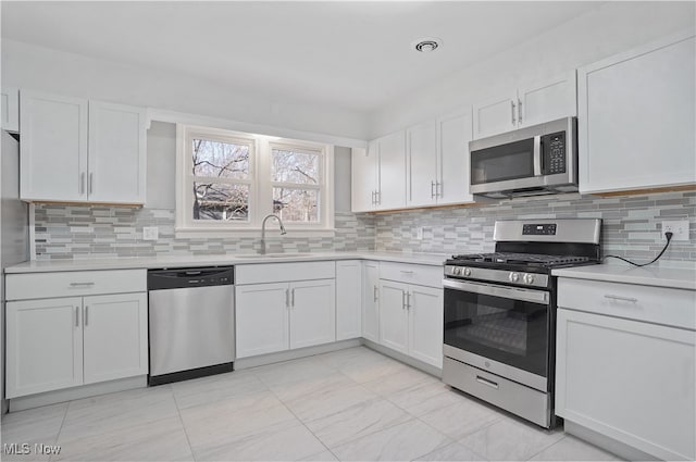 kitchen featuring white cabinets, sink, and appliances with stainless steel finishes