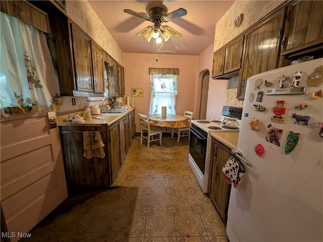 kitchen featuring ceiling fan, sink, white appliances, decorative backsplash, and dark tile patterned flooring