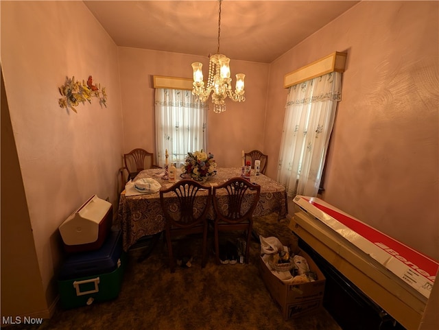 carpeted dining room featuring a chandelier