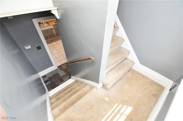 stairs featuring tile patterned flooring