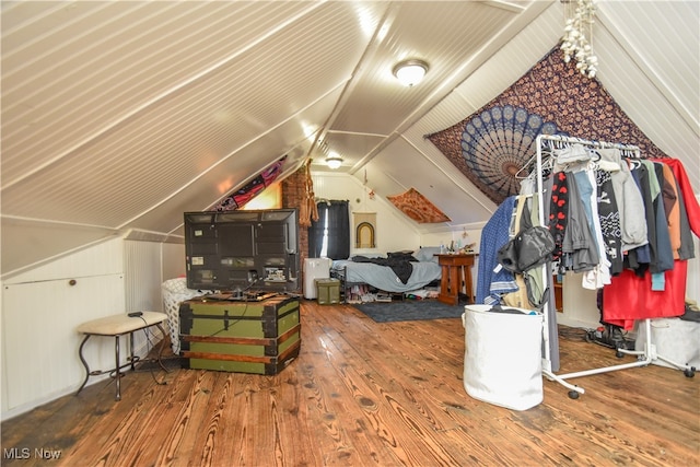 additional living space featuring hardwood / wood-style floors and vaulted ceiling