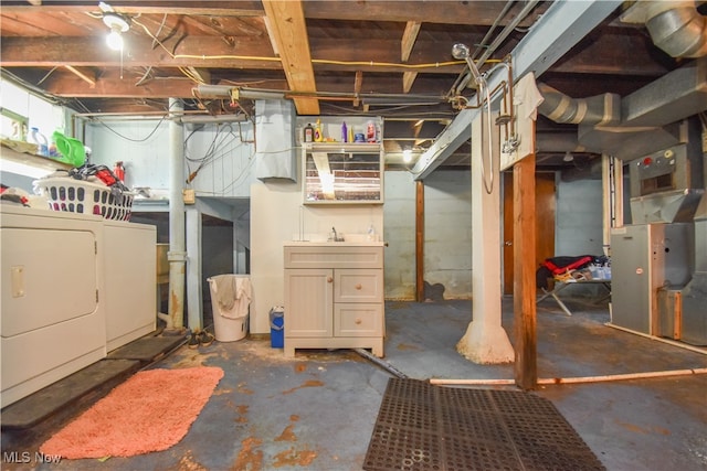 basement featuring heating unit and washer and dryer