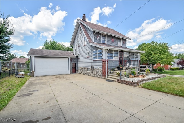 view of front of property with an outbuilding, a front lawn, and a garage