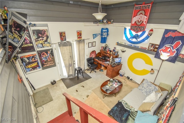 living room featuring concrete floors and lofted ceiling