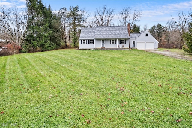 view of front facade with covered porch, a garage, and a front lawn