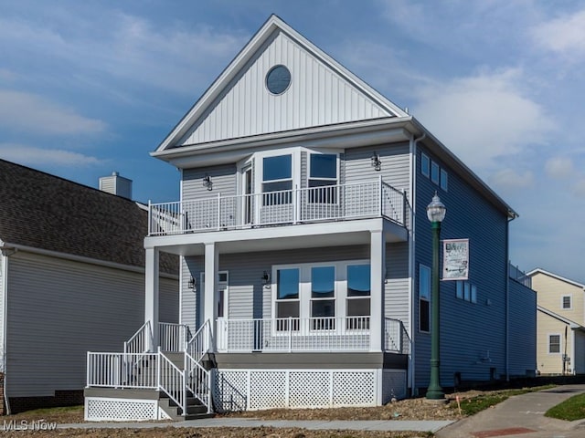 view of front of house with a balcony and covered porch