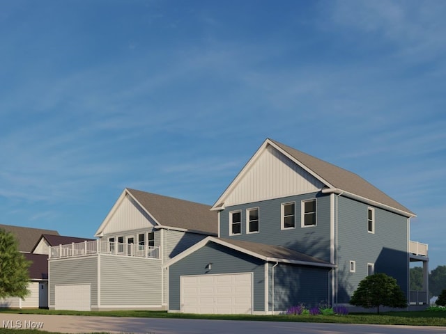 view of front of property featuring a balcony and a garage