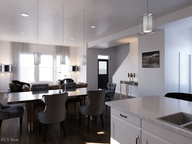 dining room featuring dark wood-type flooring and sink