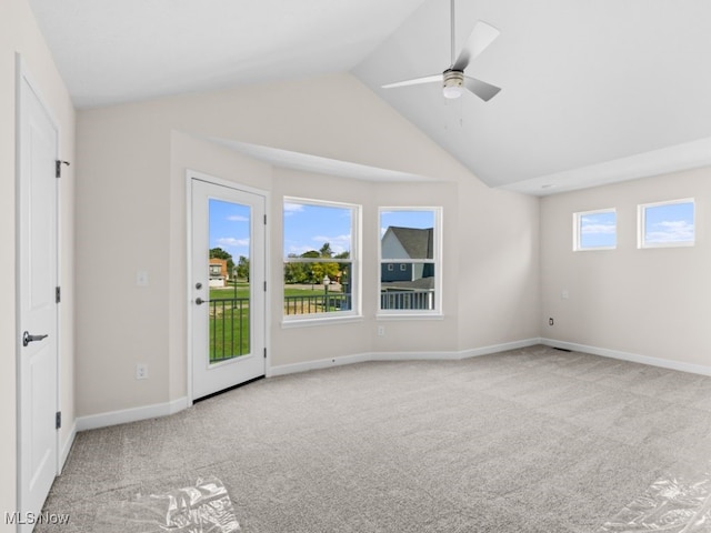 interior space featuring plenty of natural light, ceiling fan, and vaulted ceiling