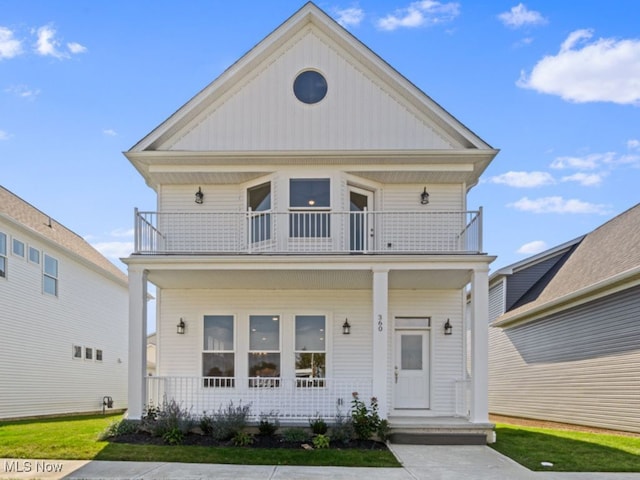 view of front of property featuring a porch and a balcony