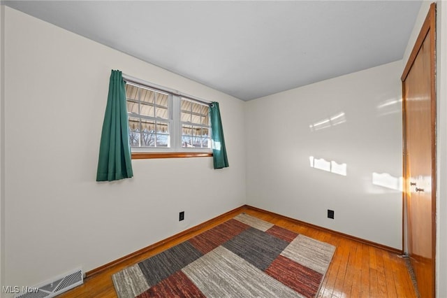 spare room with light hardwood / wood-style flooring