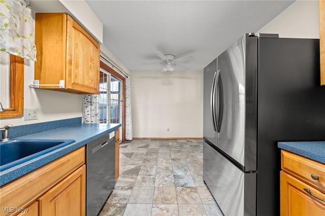 kitchen with dishwasher, ceiling fan, sink, and stainless steel refrigerator