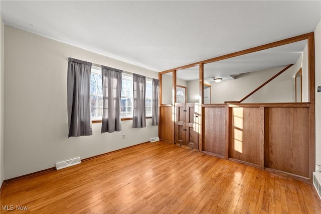 empty room with light hardwood / wood-style flooring