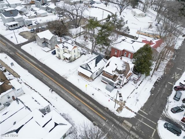 snowy aerial view with a residential view