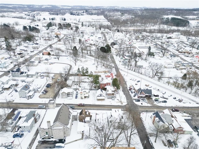 snowy aerial view with a residential view