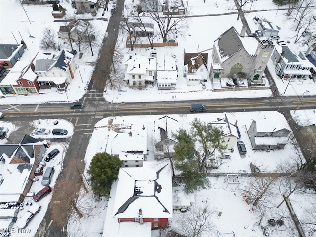 snowy aerial view with a residential view