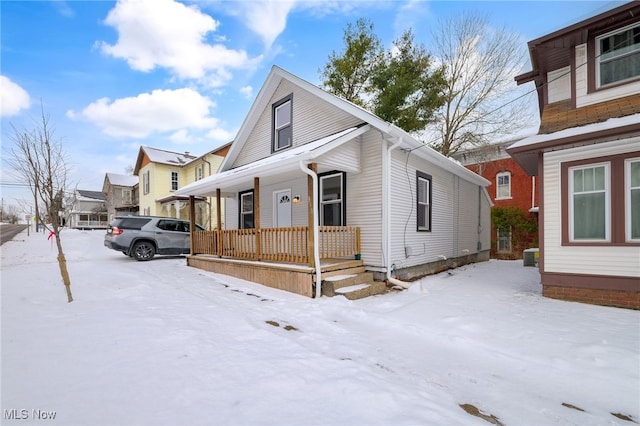 view of front of property with covered porch and central AC