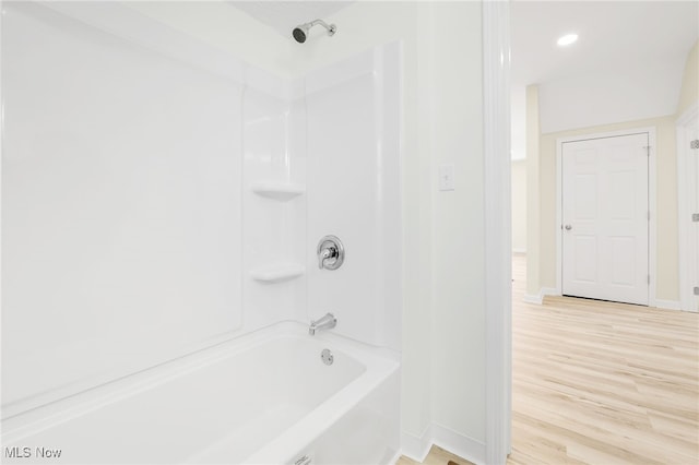 bathroom with wood-type flooring and shower / washtub combination