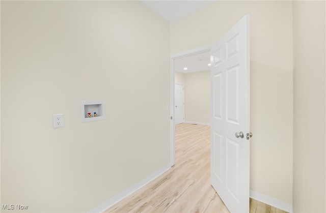 clothes washing area with hookup for a washing machine and light hardwood / wood-style floors