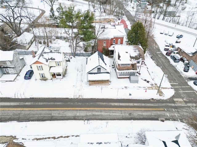 snowy aerial view featuring a residential view