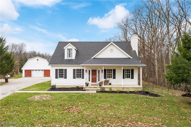 view of front of property featuring an outbuilding, a front lawn, and a garage