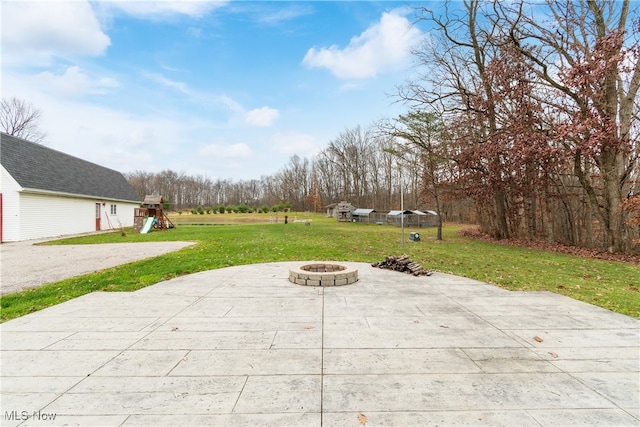 view of patio / terrace featuring a fire pit and a playground