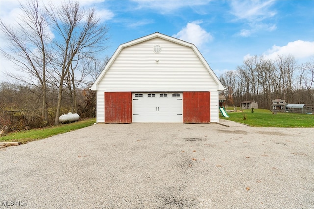 garage featuring a lawn