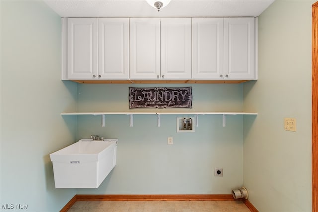 laundry room featuring hookup for an electric dryer, hookup for a washing machine, cabinets, a textured ceiling, and sink