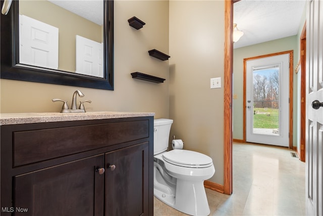 bathroom with vanity, a textured ceiling, and toilet