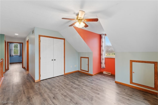 additional living space featuring ceiling fan, light hardwood / wood-style floors, and lofted ceiling