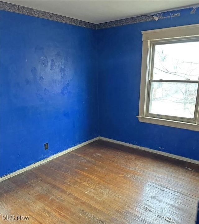 spare room with dark wood-type flooring