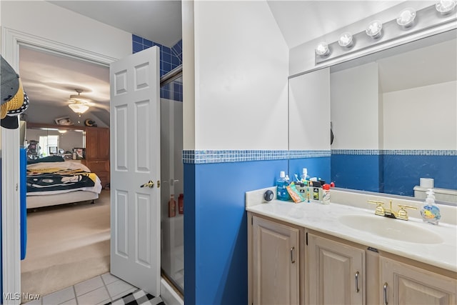 bathroom with vanity, tile patterned floors, a shower with door, and ceiling fan