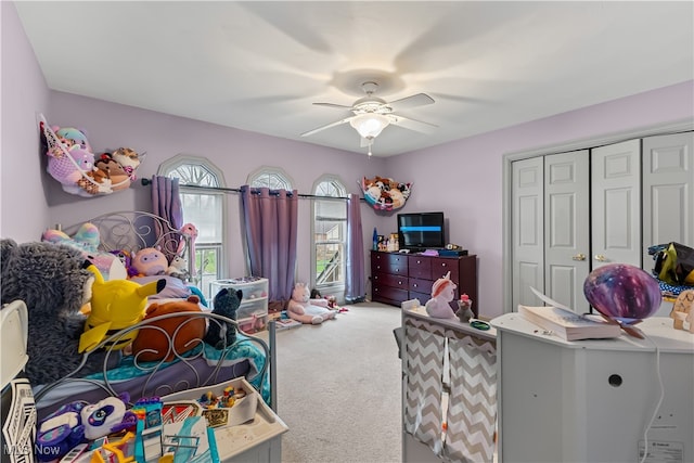 bedroom with carpet flooring, ceiling fan, and a closet