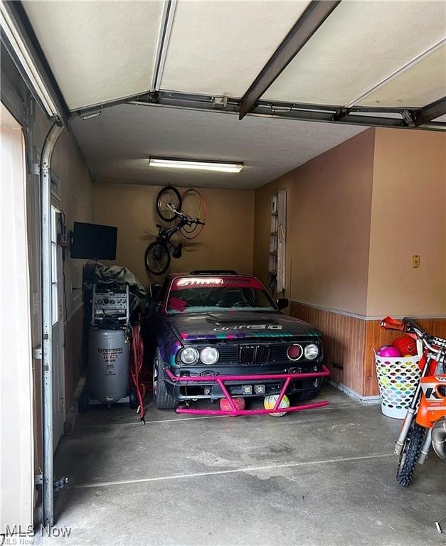 garage featuring wooden walls